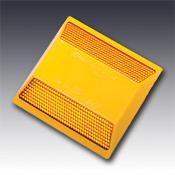 Two way amber prismatic pavement marker